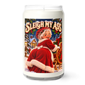 A white wax candle in a clear glass jar with a humorous Christmas-themed label that reads 'SLEIGH MY ' and features a retro illustration of a woman in a red Santa outfit.